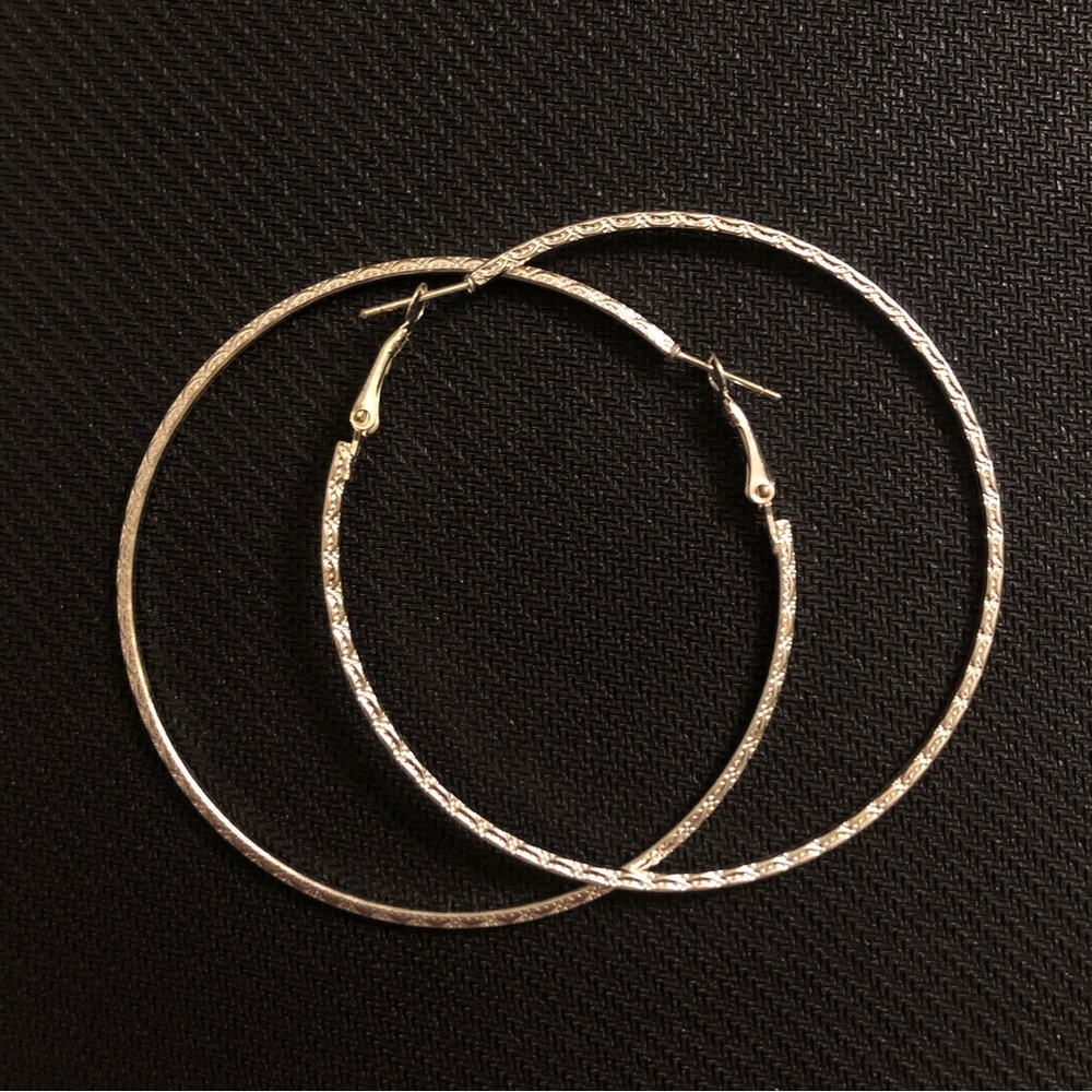 Big silver hoops with subtle geometric pattern on outside, smooth on edge